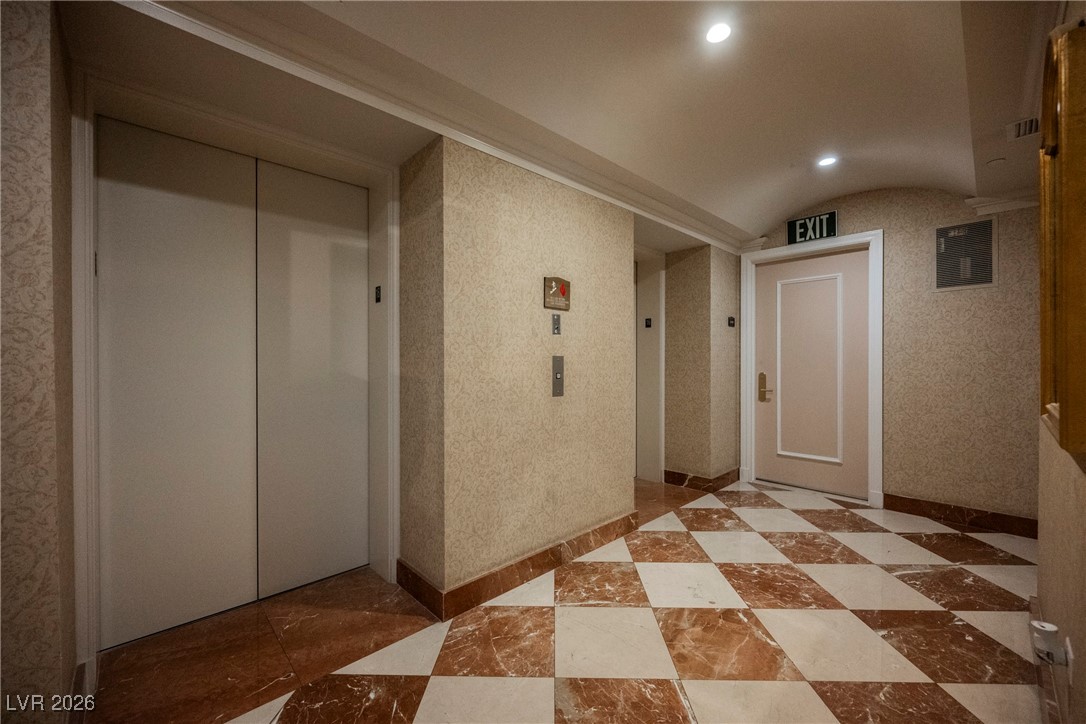 2877 Paradise Road, Unit 1604 Las Vegas, NV 89109 - Photo 8 of 47 Hallway featuring elevator, vaulted ceiling, and recessed lighting