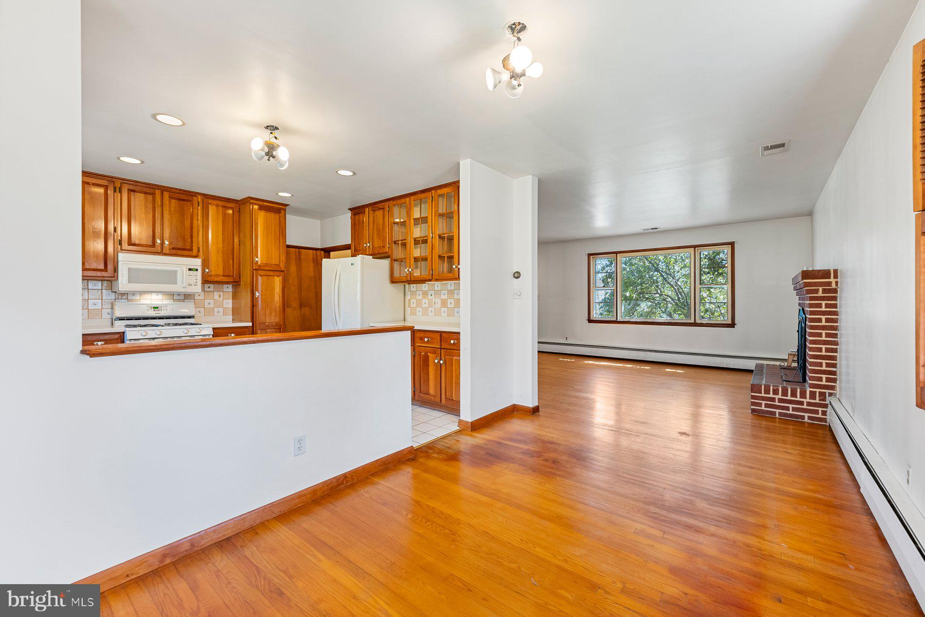 104 Hillside Road Baltimore, MD 21228 - Photo 11 of 34 a view of a kitchen with wooden floor and a window