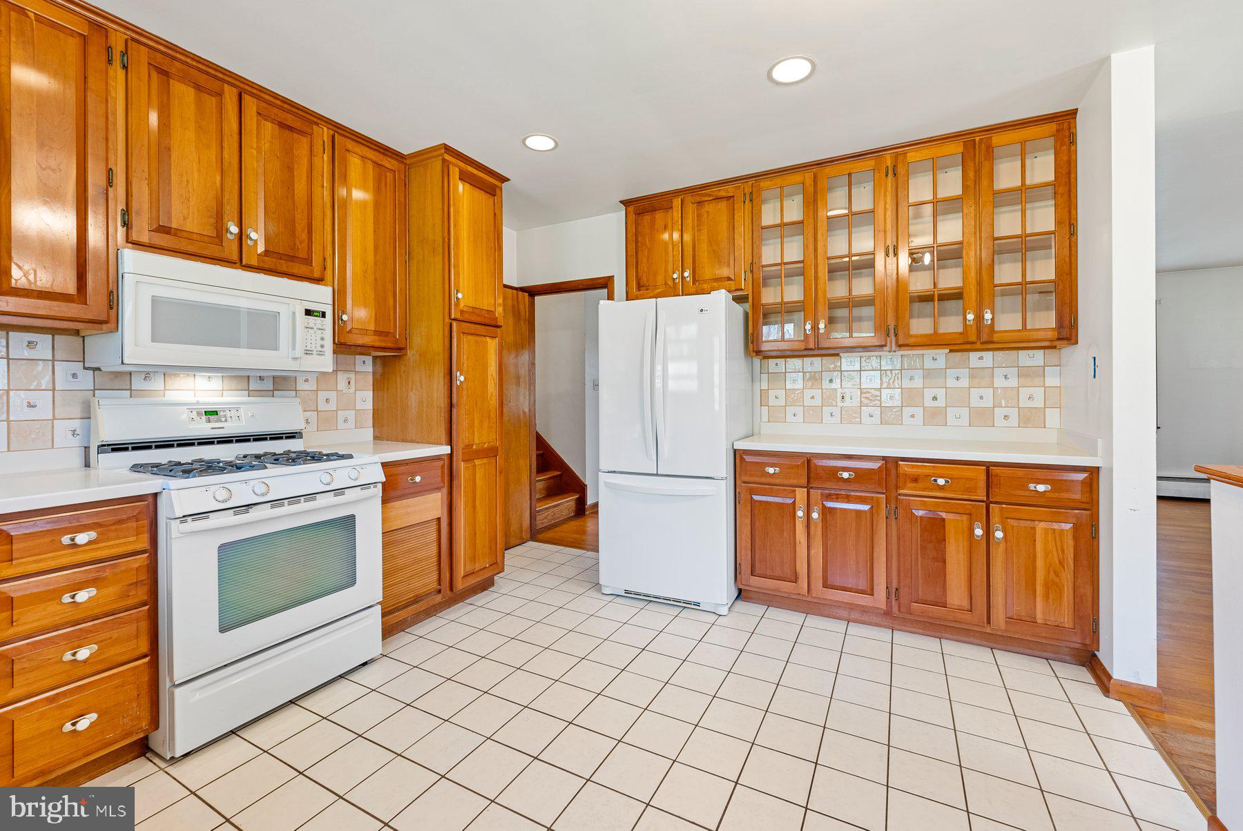 104 Hillside Road Baltimore, MD 21228 - Photo 12 of 34 a kitchen with stainless steel appliances granite countertop a refrigerator a stove and wooden cabinets