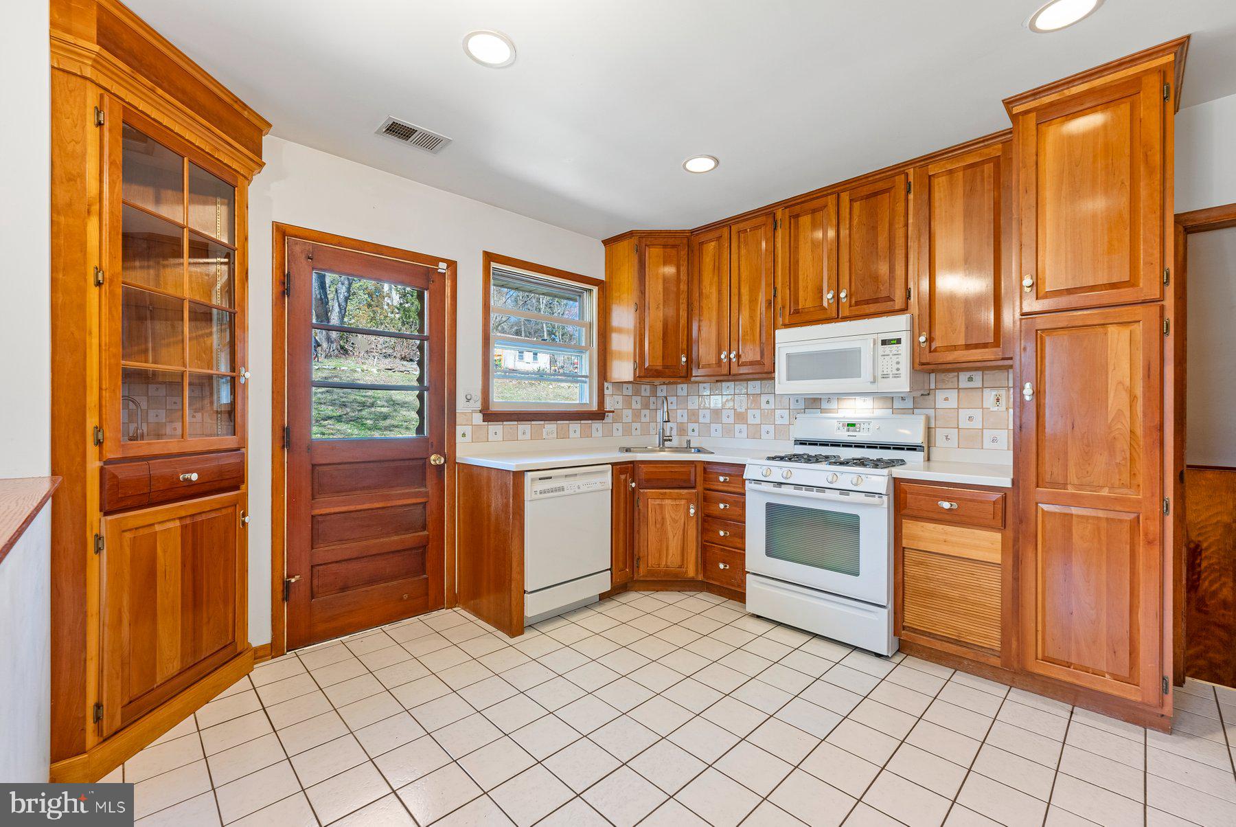 104 Hillside Road Baltimore, MD 21228 - Photo 14 of 34 a kitchen with stainless steel appliances granite countertop a refrigerator and a stove top oven
