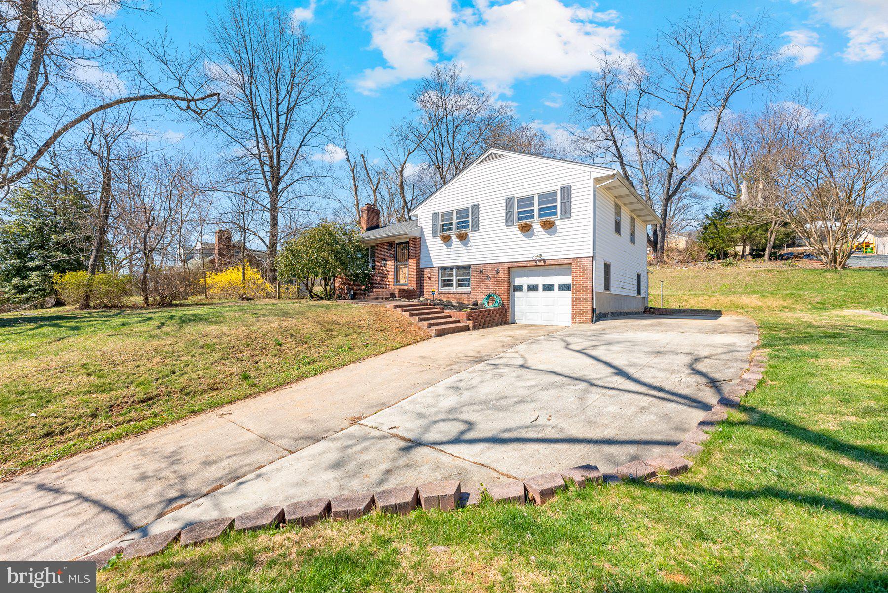 104 Hillside Road Baltimore, MD 21228 - Photo 2 of 34 a view of a white house with a yard and sitting area