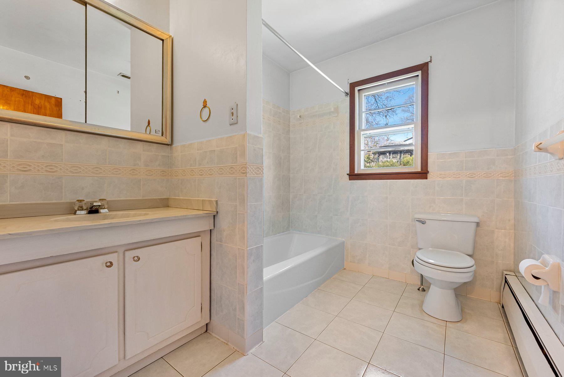 104 Hillside Road Baltimore, MD 21228 - Photo 22 of 34 a bathroom with a sink a toilet and bathtub