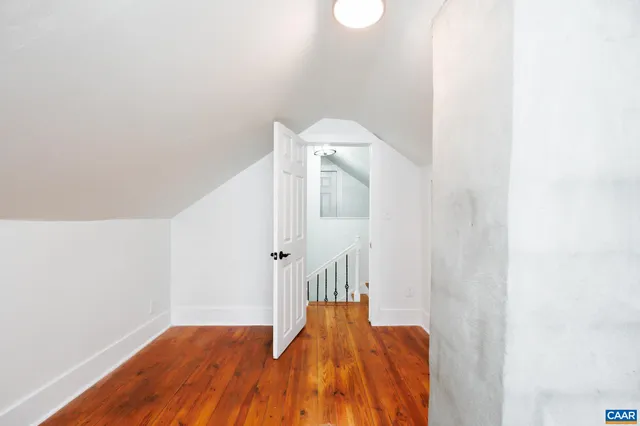 a view of a bedroom with wooden floor