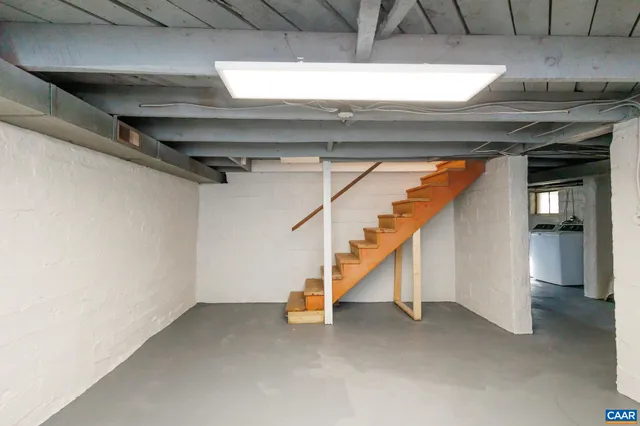 a view of empty room with wooden floor and windows
