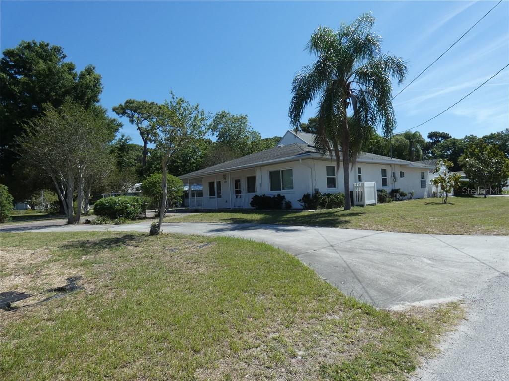 5816 Van Buren Street New Port Richey, FL 34653 - Photo 1 of 1 a house with palm tree in front of it