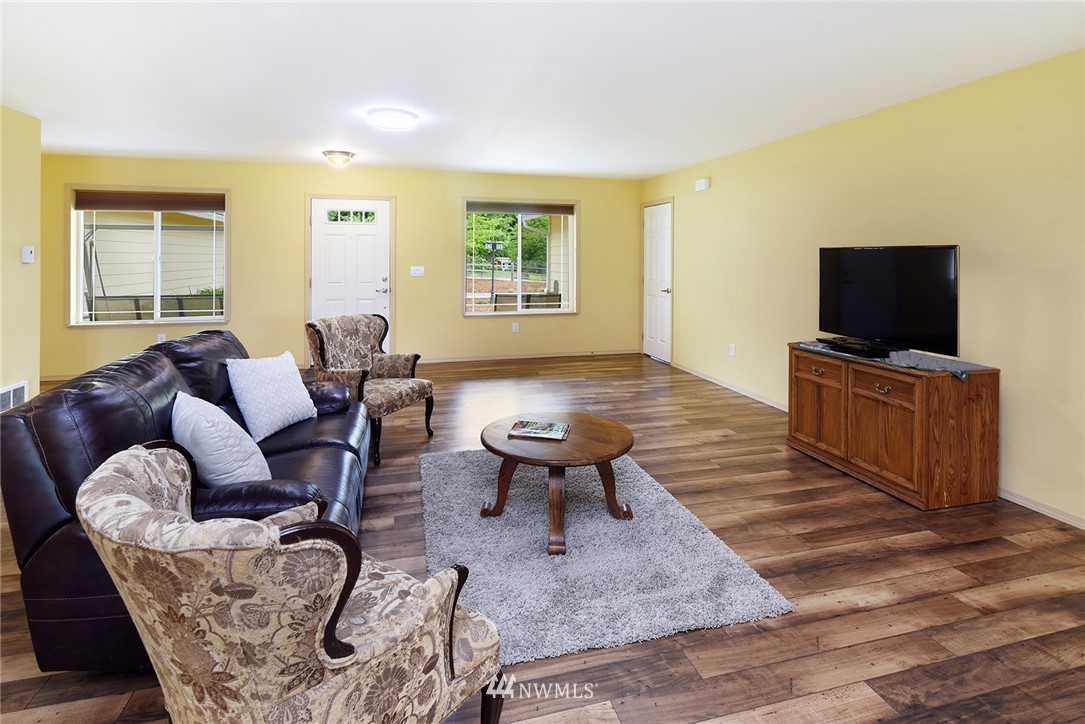 1450 Southeast Spruce Road Port Orchard, WA 98367 - Photo 3 of 40 a living room with furniture and a flat screen tv