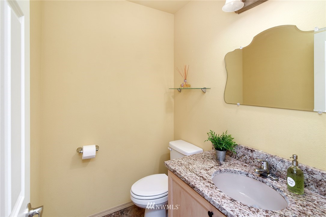 1450 Southeast Spruce Road Port Orchard, WA 98367 - Photo 21 of 40 a bathroom with a granite countertop sink and a mirror