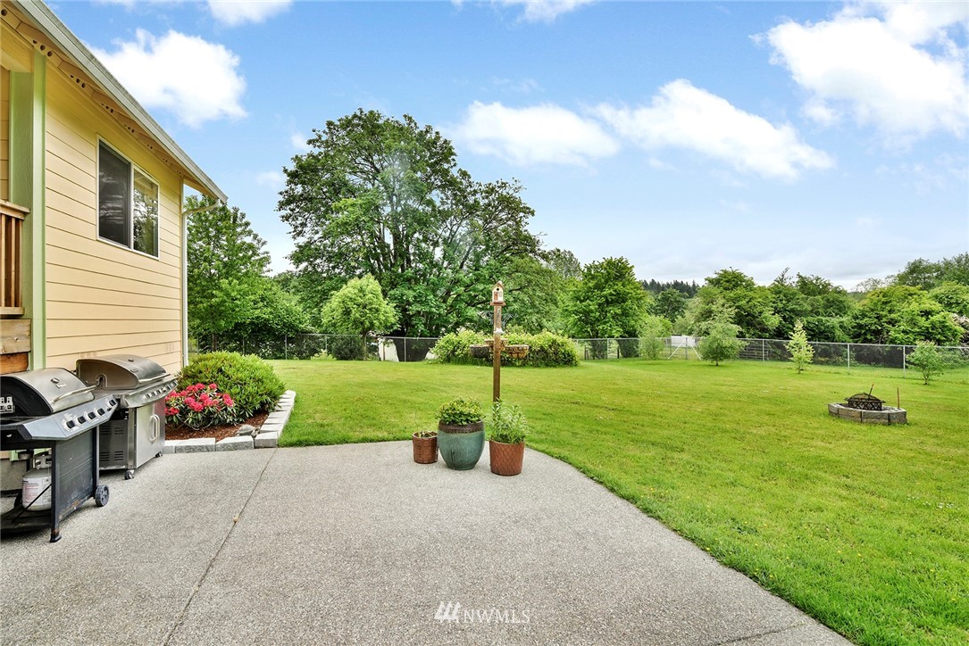 1450 Southeast Spruce Road Port Orchard, WA 98367 - Photo 26 of 40 a view of a garden with plants and large trees