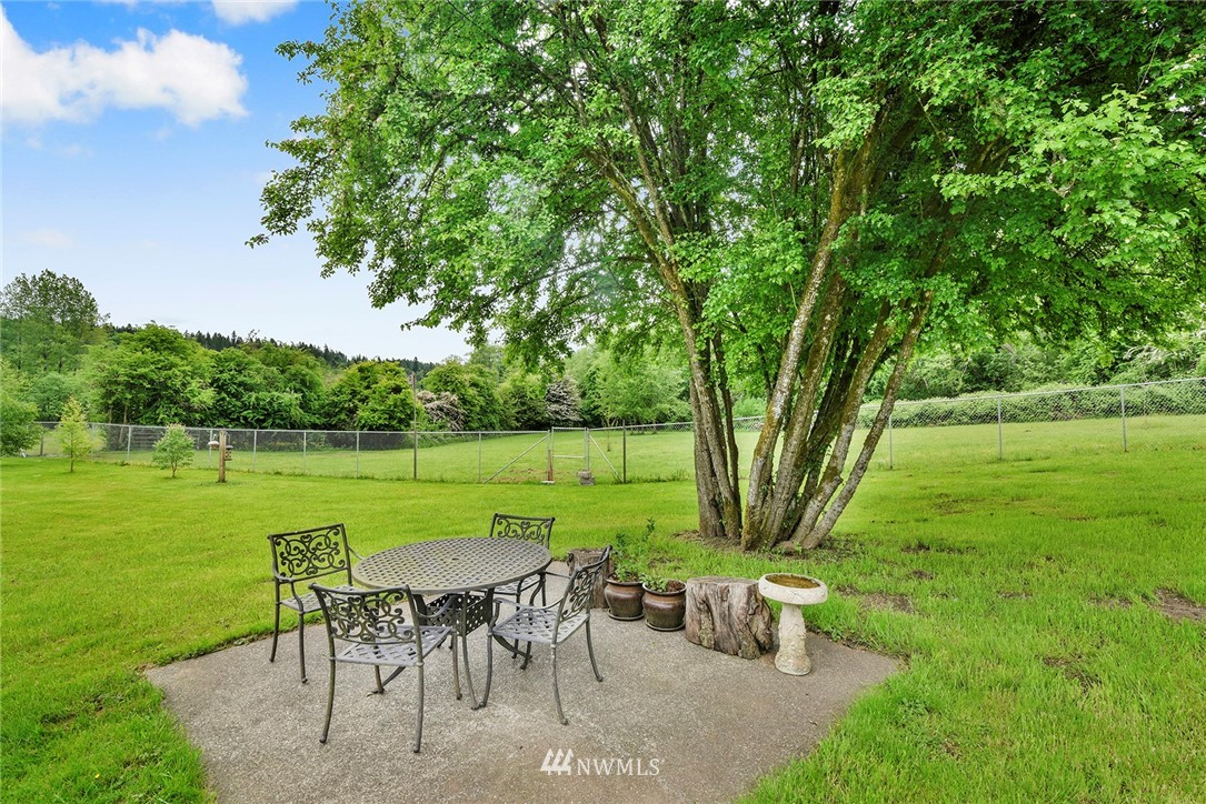 1450 Southeast Spruce Road Port Orchard, WA 98367 - Photo 31 of 40 a view of a table and chairs in the garden