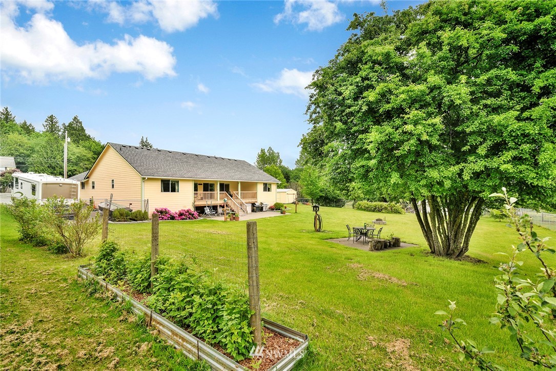 1450 Southeast Spruce Road Port Orchard, WA 98367 - Photo 33 of 40 a view of a house with a big yard plants and large trees