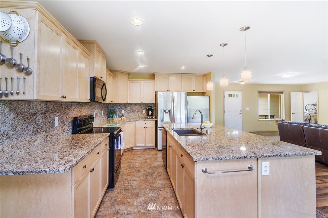 1450 Southeast Spruce Road Port Orchard, WA 98367 - Photo 8 of 40 a kitchen with stainless steel appliances granite countertop stove top oven a sink and dishwasher