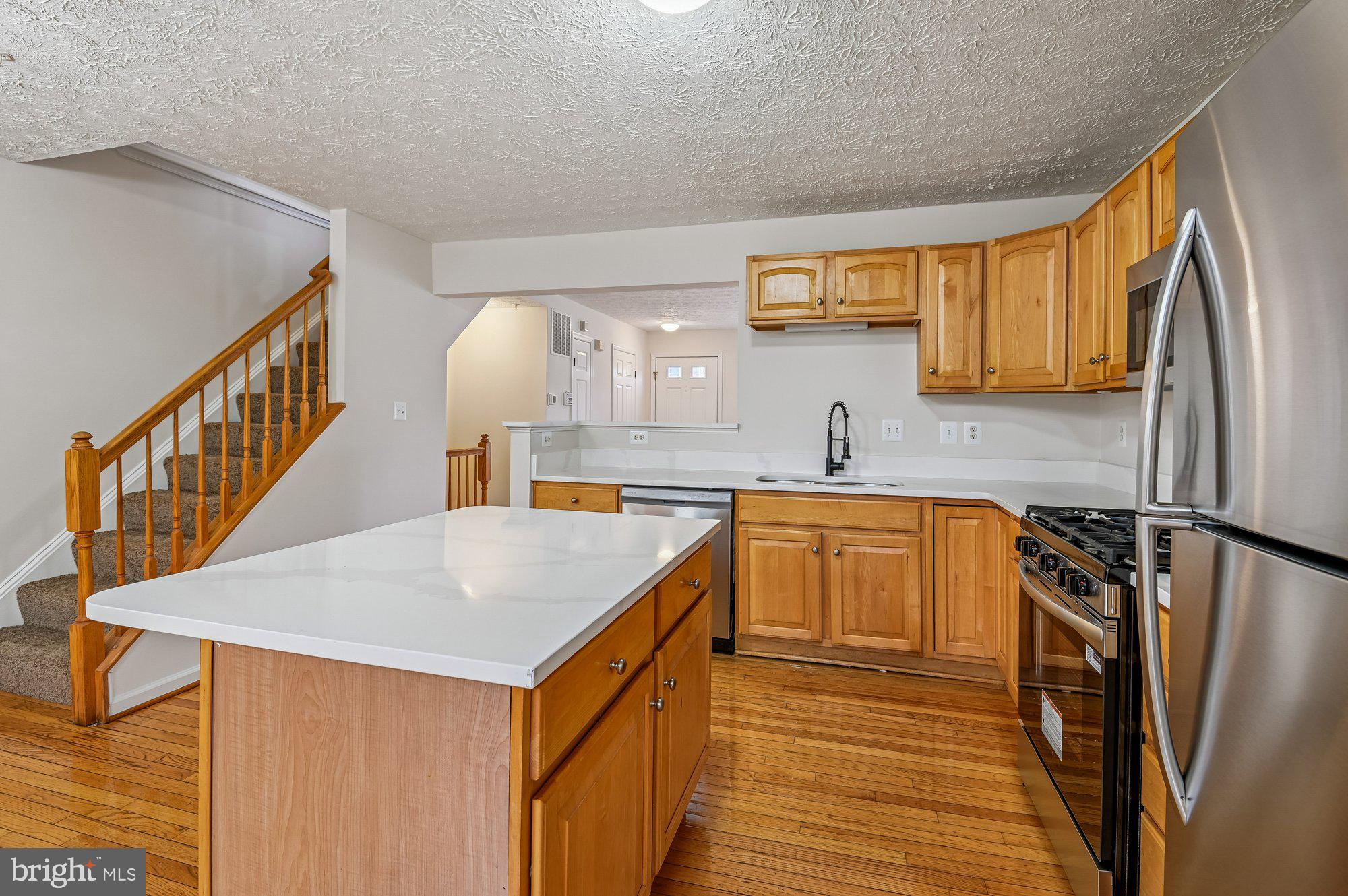 2670 Rainy Spring Court Odenton, MD 21113 - Photo 16 of 79 a kitchen with stainless steel appliances granite countertop a sink stove and refrigerator