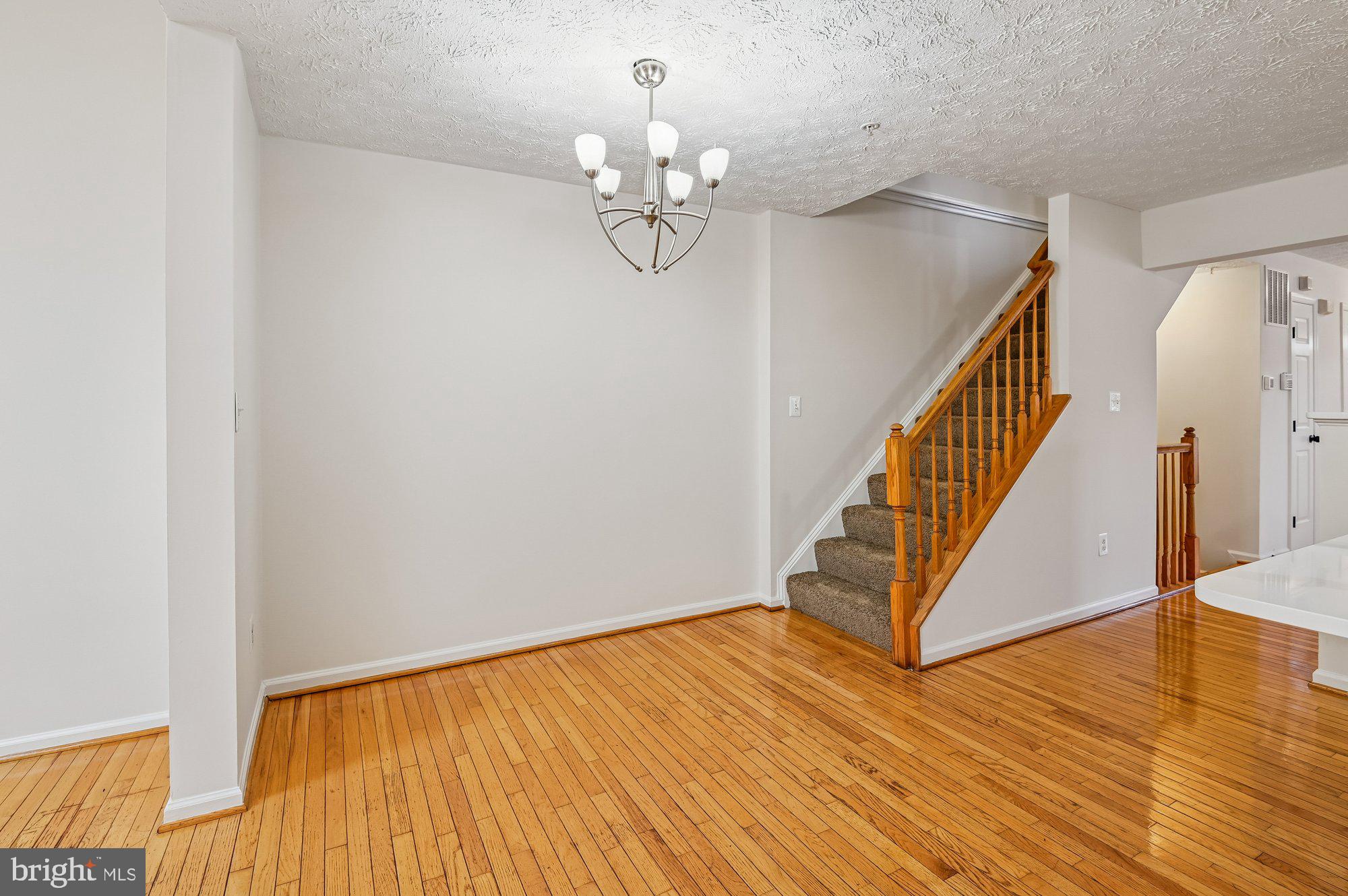 2670 Rainy Spring Court Odenton, MD 21113 - Photo 18 of 79 a view of a hallway with wooden floor and staircase