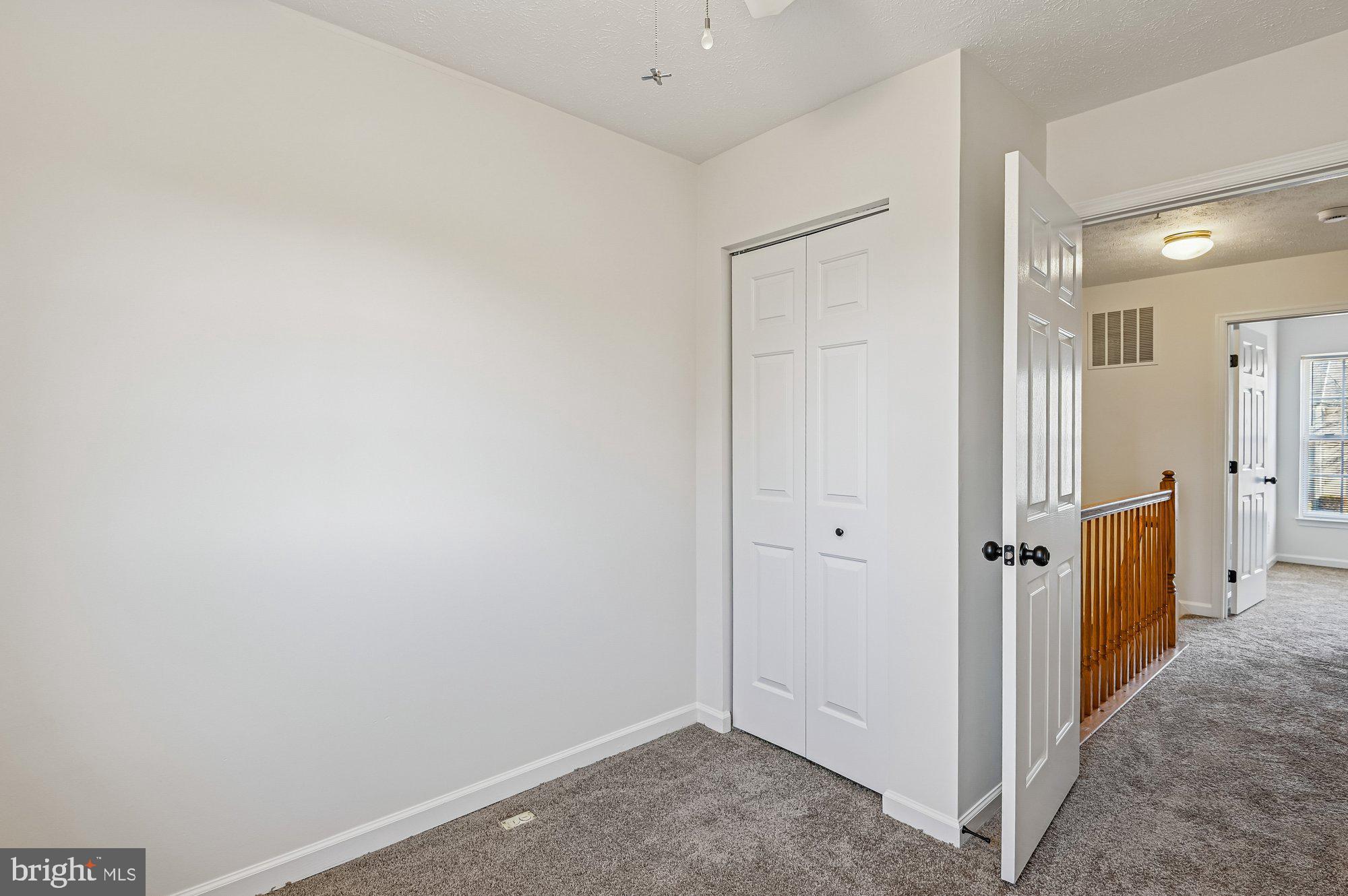 2670 Rainy Spring Court Odenton, MD 21113 - Photo 35 of 79 a view of a hallway with a refrigerator and a wooden floor