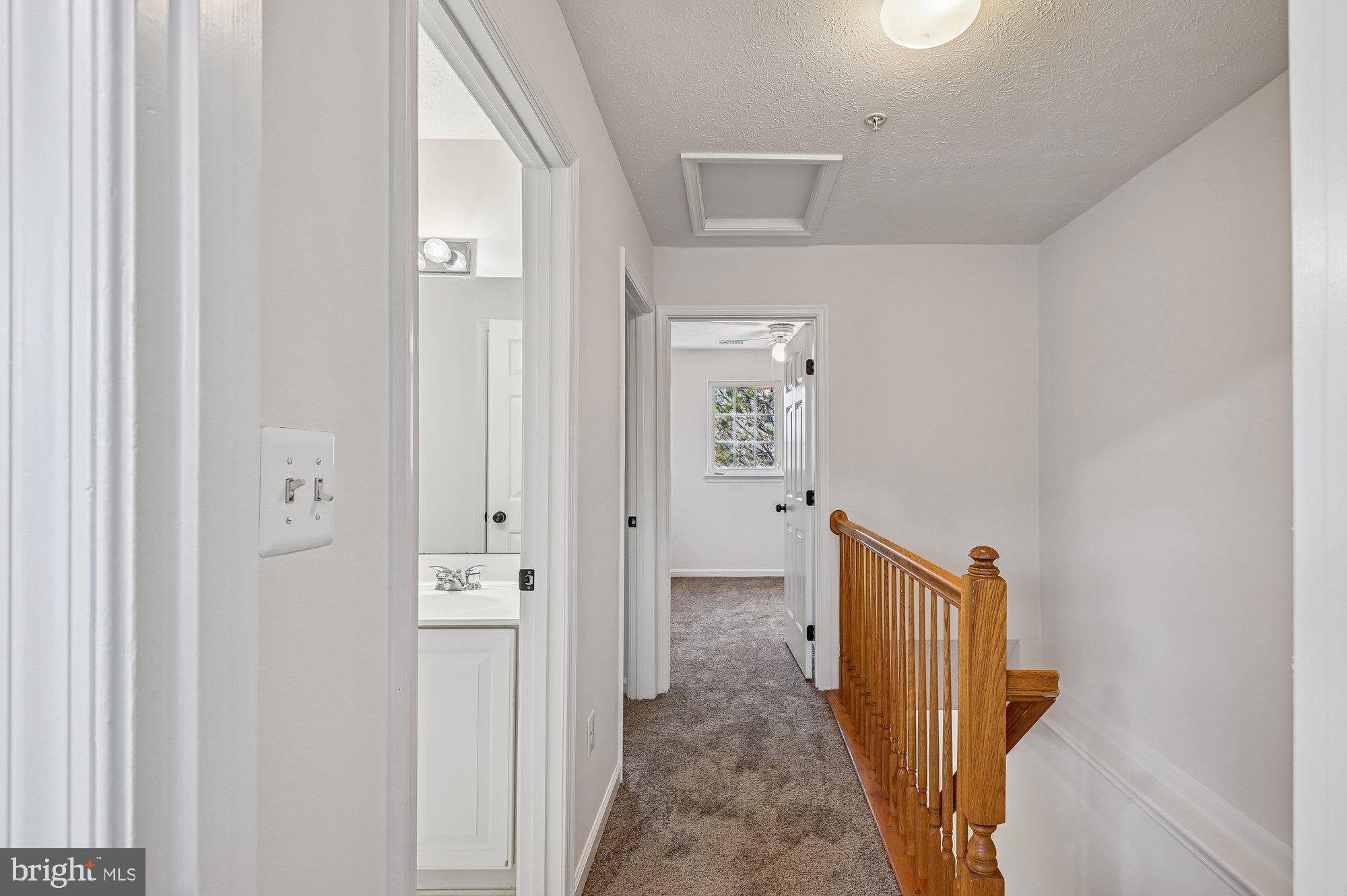 2670 Rainy Spring Court Odenton, MD 21113 - Photo 42 of 79 a view of a hallway with wooden floor and staircase