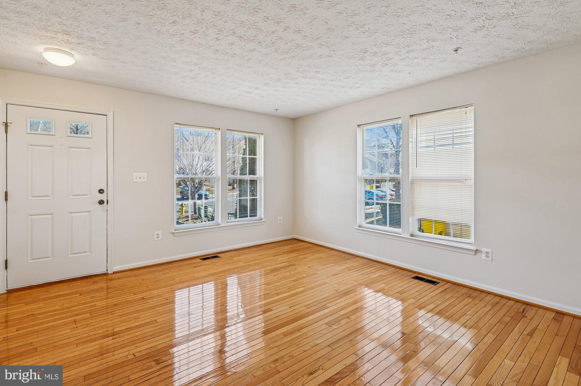 2670 Rainy Spring Court Odenton, MD 21113 - Photo 7 of 79 a view of an empty room with window and wooden floor