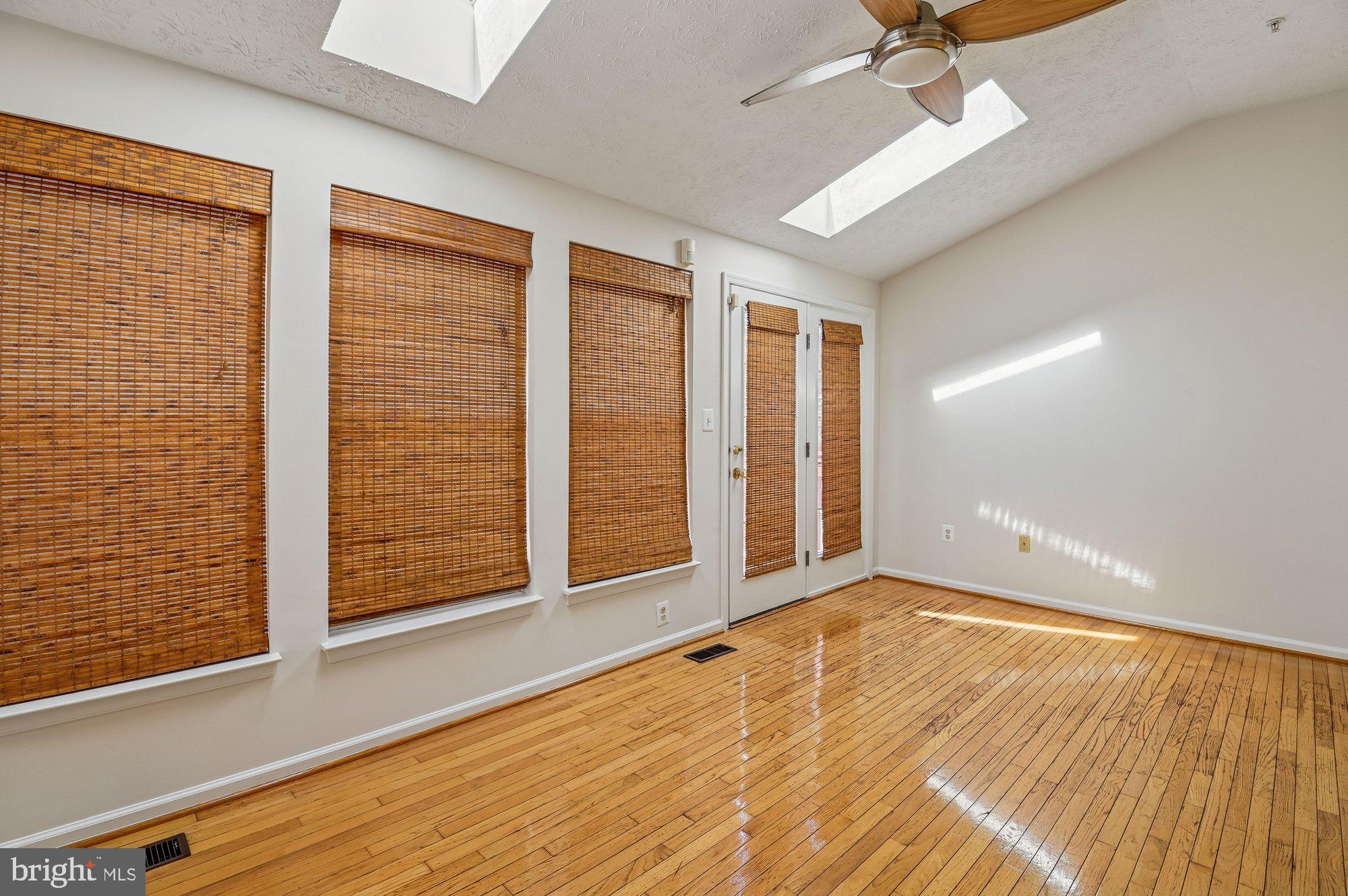 2670 Rainy Spring Court Odenton, MD 21113 - Photo 10 of 79 an empty room with wooden floor fan and windows
