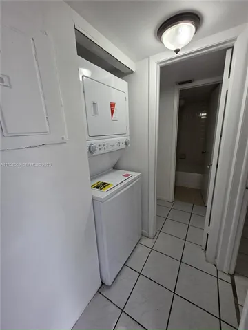 a utility room with cabinets washer and dryer