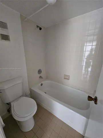 a bathroom with a toilet and bathtub