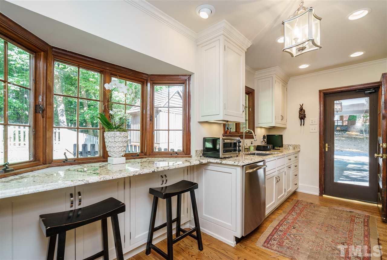 1101 Hymettus Court Raleigh, NC 27607 - Photo 11 of 25 a kitchen with stainless steel appliances granite countertop a stove a sink and a refrigerator
