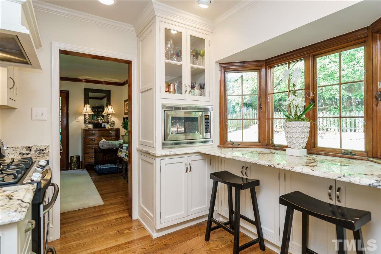 1101 Hymettus Court Raleigh, NC 27607 - Photo 12 of 25 a kitchen with a stove a sink and a refrigerator