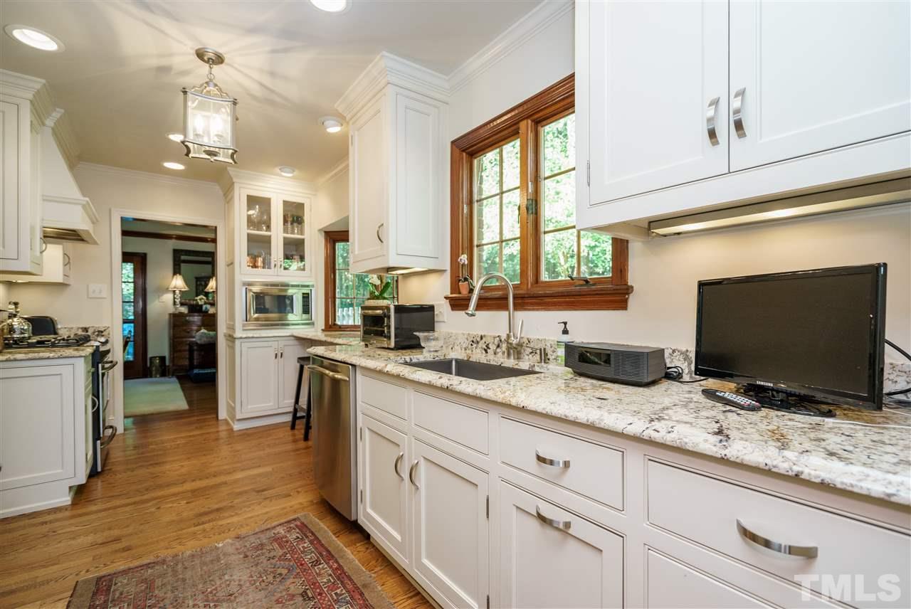 1101 Hymettus Court Raleigh, NC 27607 - Photo 13 of 25 a open kitchen with granite countertop a sink and white appliances