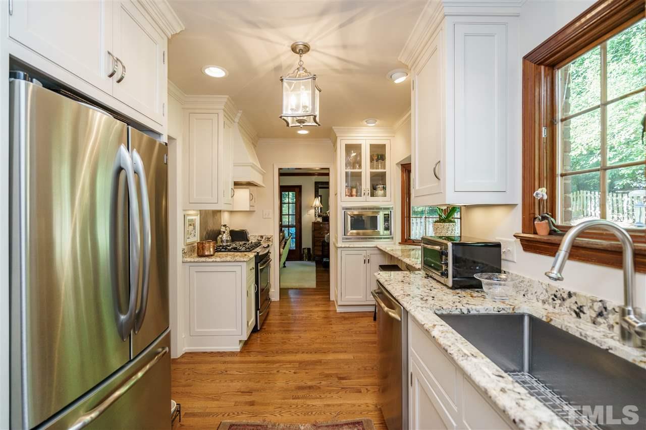 1101 Hymettus Court Raleigh, NC 27607 - Photo 14 of 25 a kitchen with stainless steel appliances granite countertop a refrigerator a stove a sink and a refrigerator