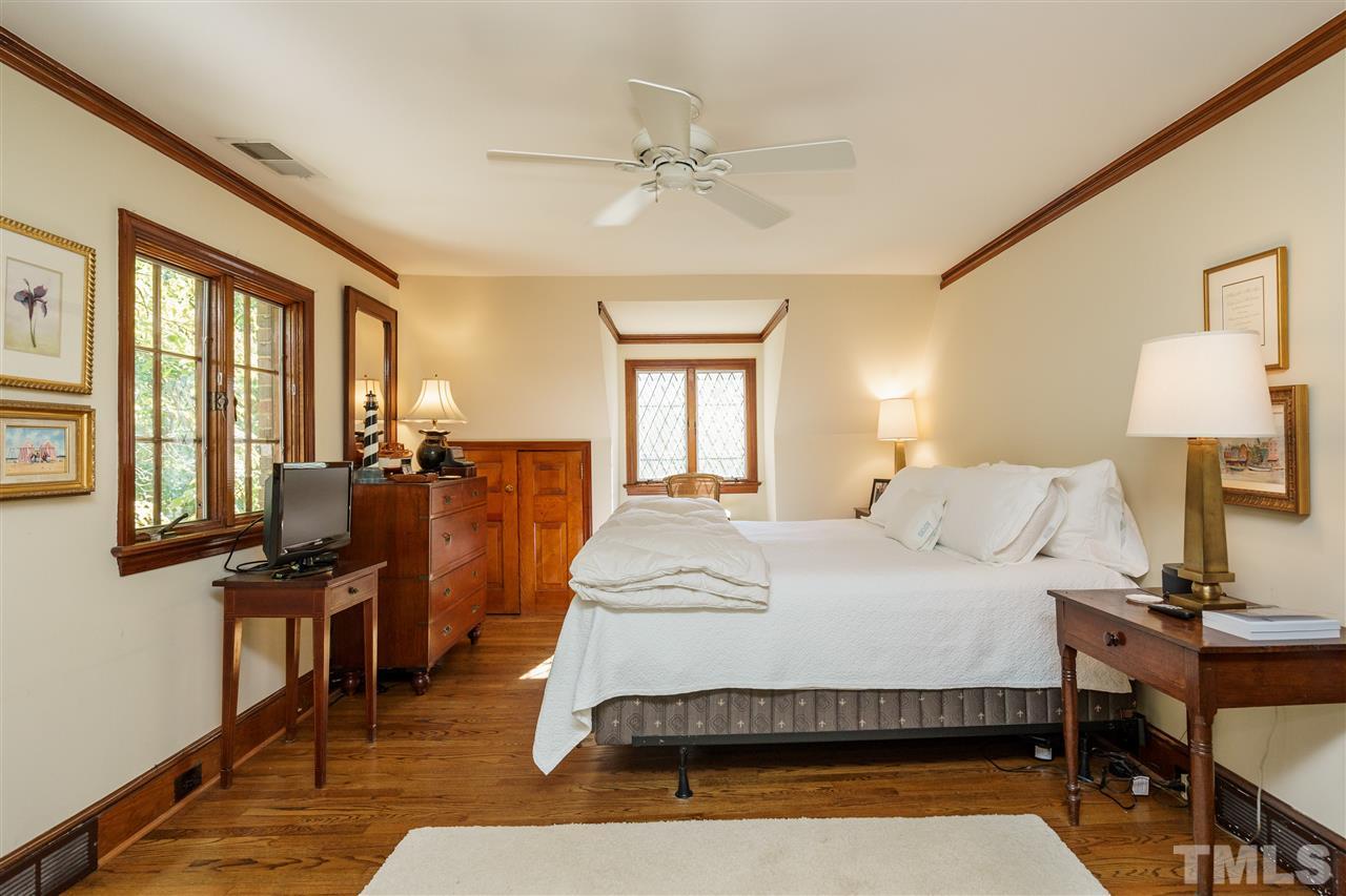 1101 Hymettus Court Raleigh, NC 27607 - Photo 16 of 25 a bedroom with a bed and wooden floor