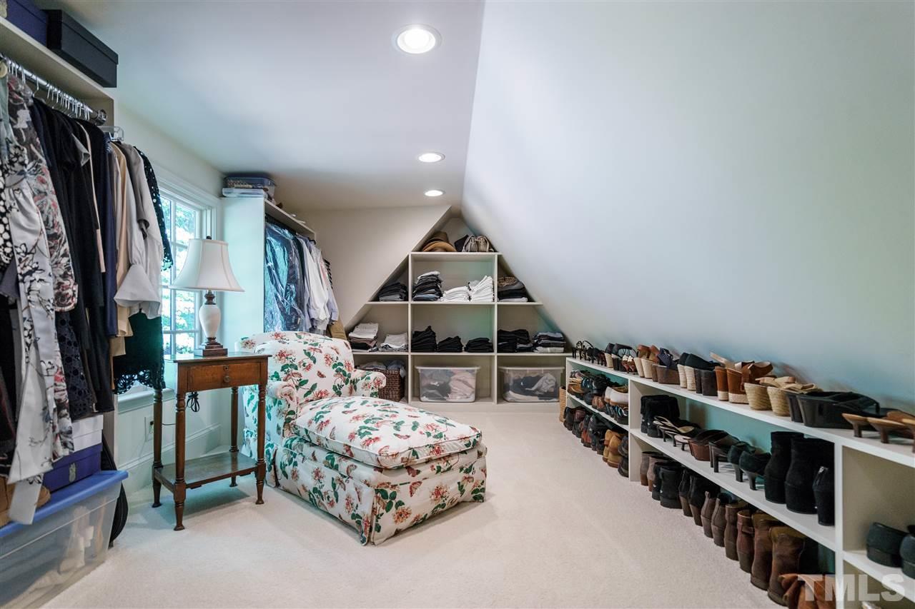 1101 Hymettus Court Raleigh, NC 27607 - Photo 19 of 25 a living room with furniture a fireplace and a book shelf