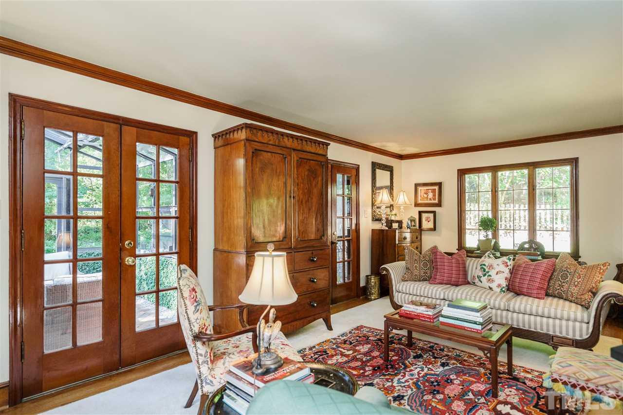 1101 Hymettus Court Raleigh, NC 27607 - Photo 5 of 25 a living room with furniture and a floor to ceiling window