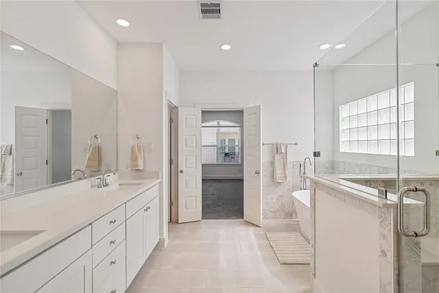 a bathroom with a double vanity sink a mirror and a shower