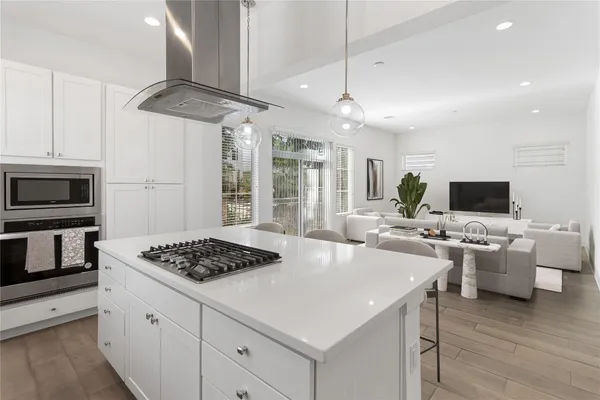 a large kitchen with kitchen island a sink stainless steel appliances and cabinets