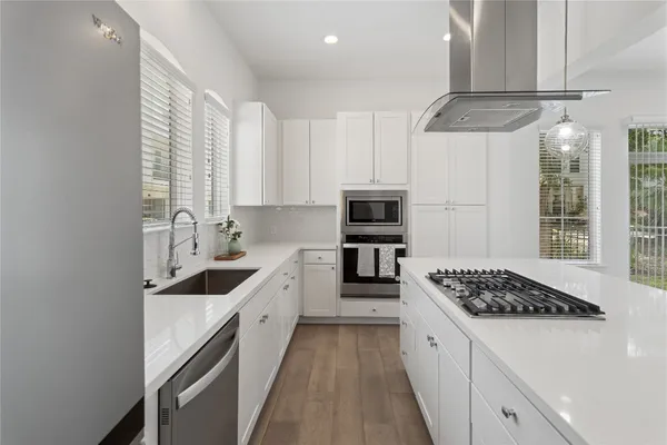 a bathroom with a double vanity sink a mirror and a shower