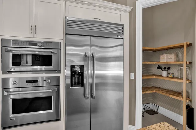 a kitchen with a refrigerator stove and cabinets