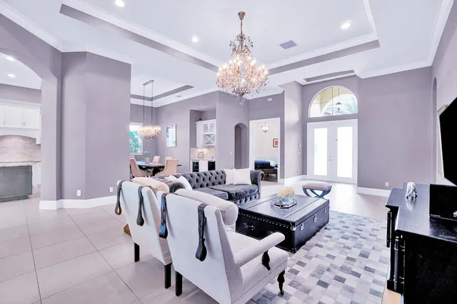 a view of a dining room with furniture and a chandelier