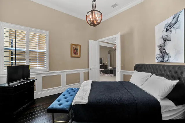 a bedroom with a bed and a television