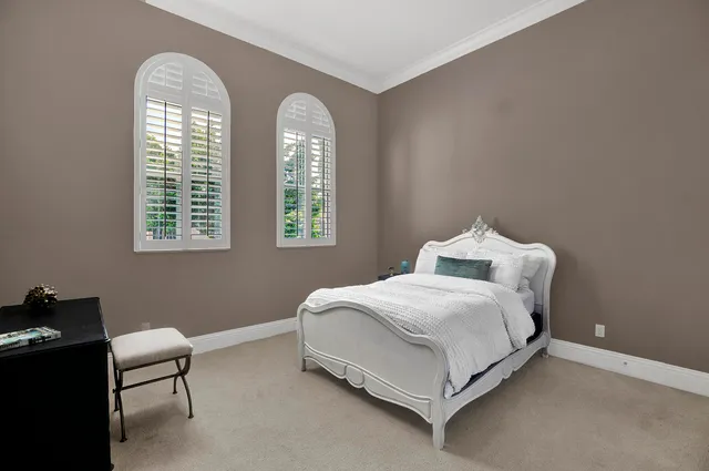 a bedroom with a bed lamp and a window
