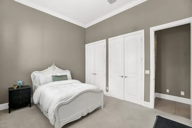 a bedroom with a bed and a night stand