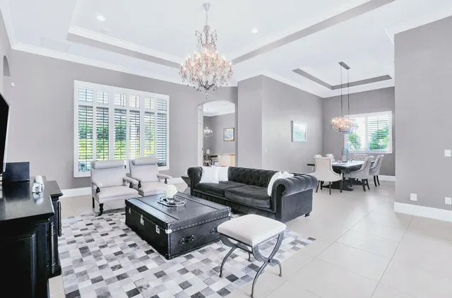 a living room with furniture and a chandelier