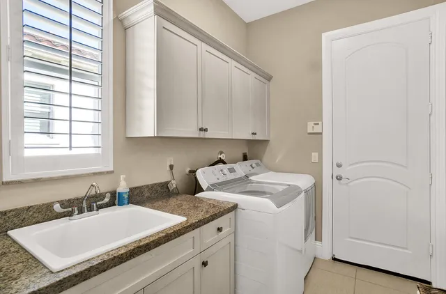 a bathroom with a granite countertop sink and a vanity