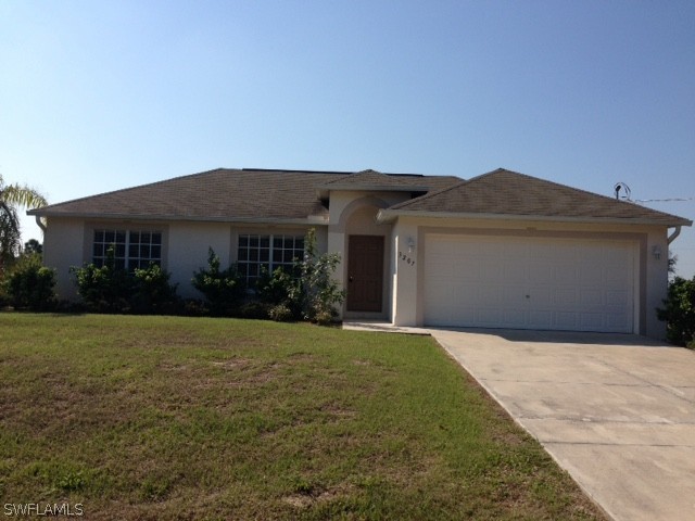 3207 54th Street West Lehigh Acres, FL 33971 - Photo 1 of 10 a front view of house with yard and trees