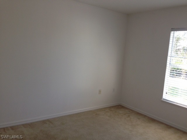3207 54th Street West Lehigh Acres, FL 33971 - Photo 6 of 10 an empty room with a window