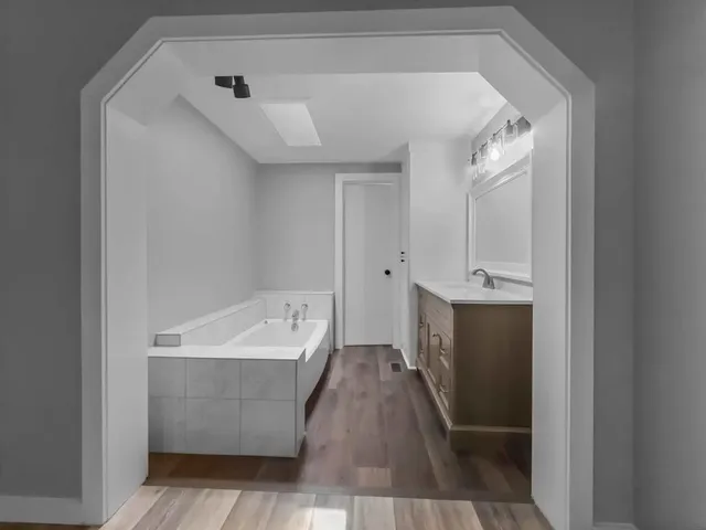 wooden floor in an empty room with a window