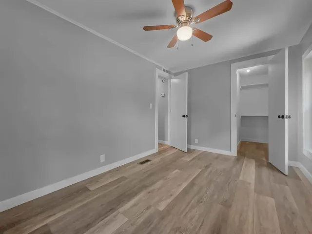 a view of a backyard with floor to ceiling window and wooden fence