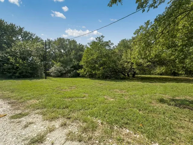a view of outdoor space with trees all around