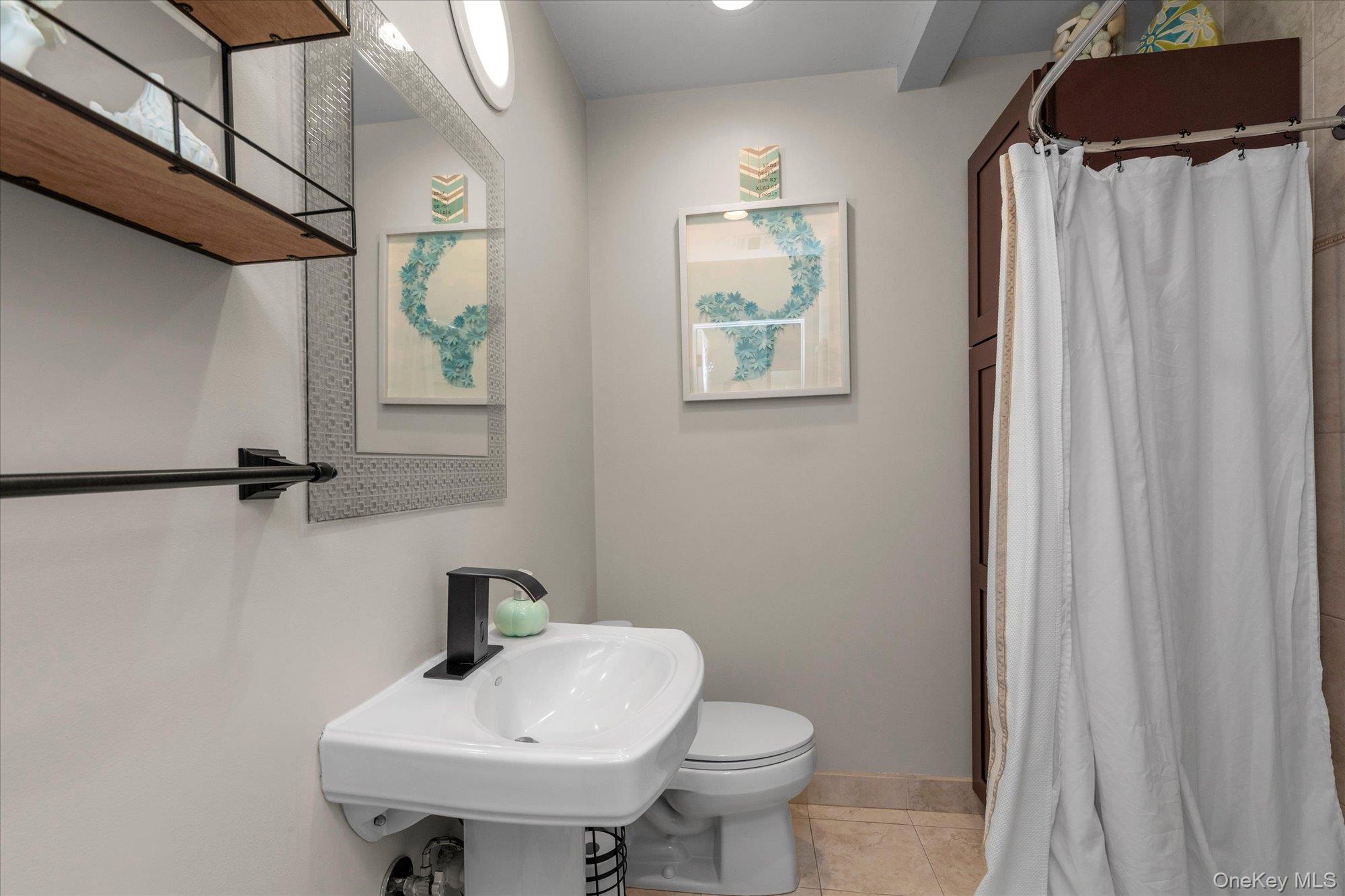 32 Ashley Circle Commack, NY 11725 - Photo 12 of 23 a bathroom with a sink toilet and a mirror
