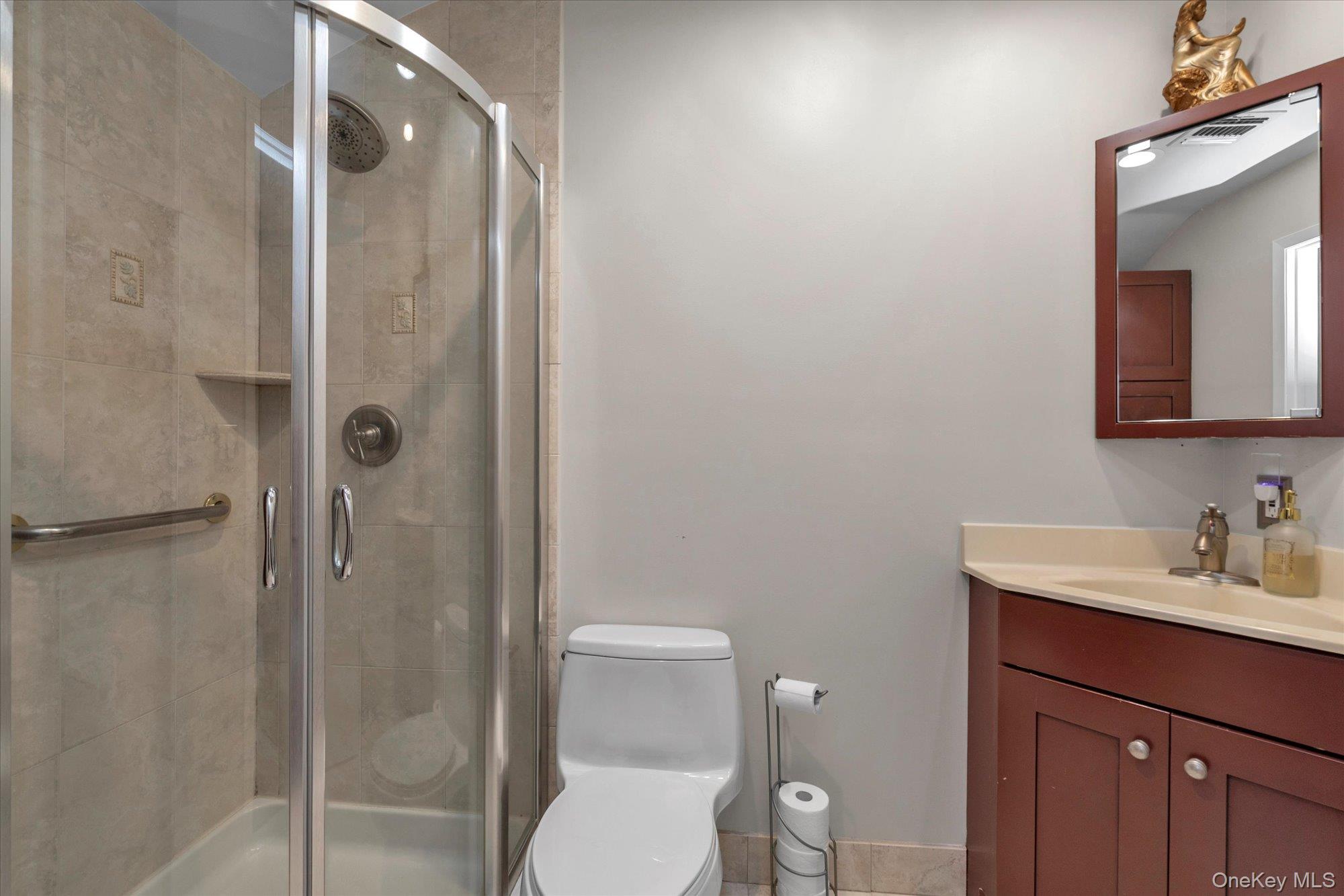 32 Ashley Circle Commack, NY 11725 - Photo 13 of 23 a bathroom with a toilet a sink and shower