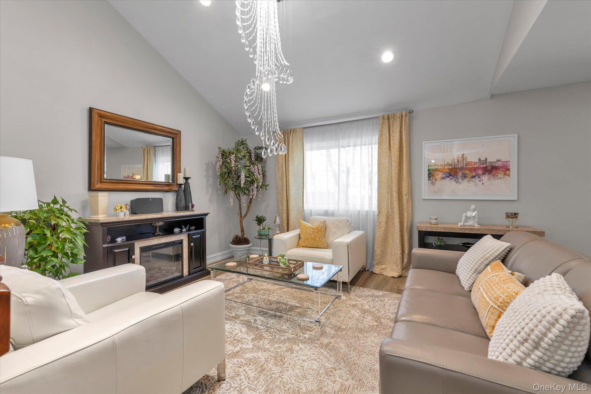 32 Ashley Circle Commack, NY 11725 - Photo 2 of 23 a living room with furniture or couch and a chandelier