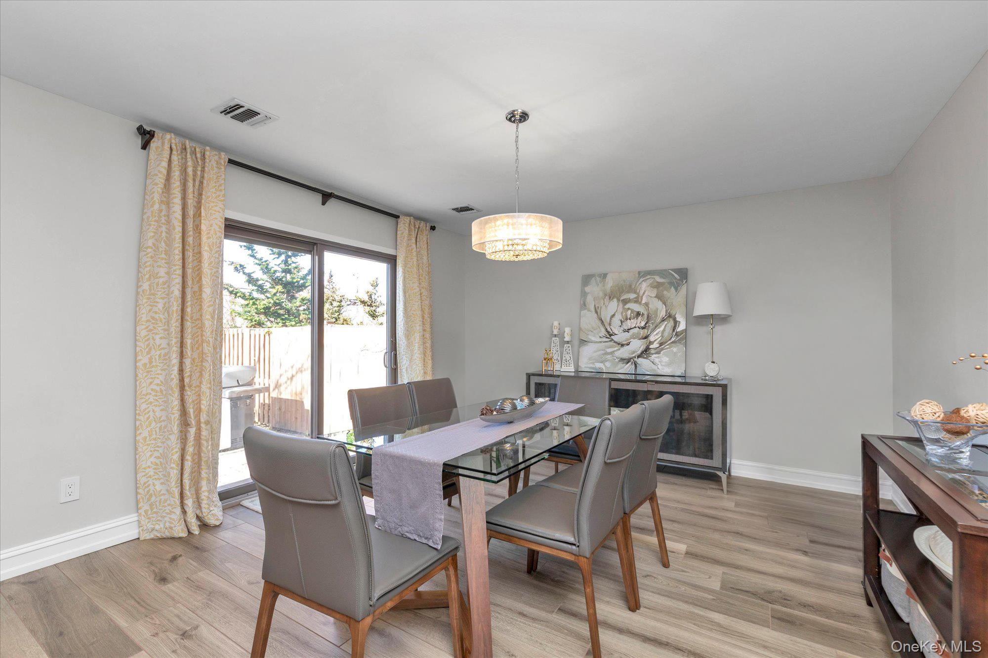 32 Ashley Circle Commack, NY 11725 - Photo 6 of 23 a view of a dining room with furniture window and wooden floor