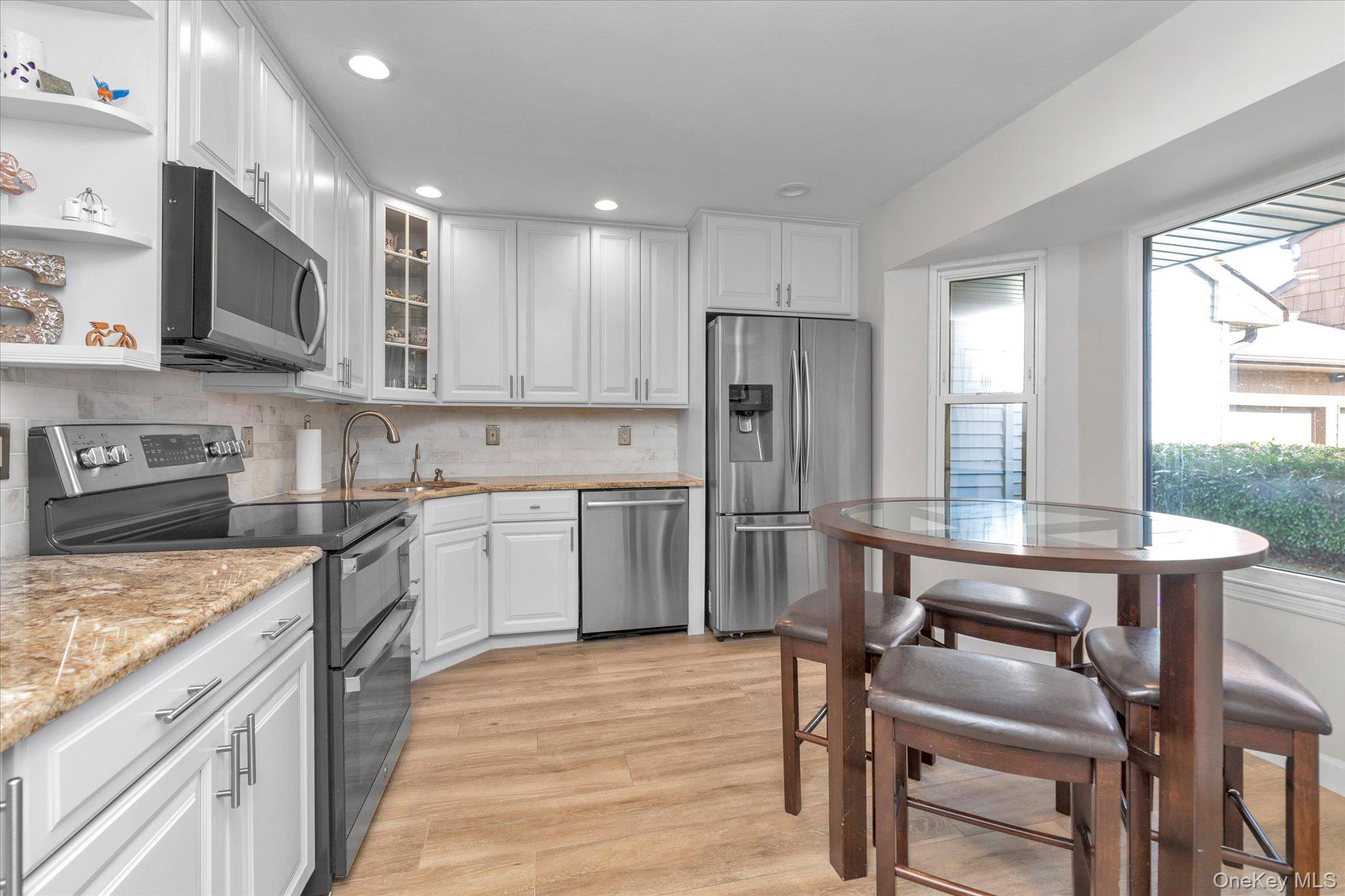 32 Ashley Circle Commack, NY 11725 - Photo 8 of 23 a kitchen with stainless steel appliances a stove a sink refrigerator and a microwave